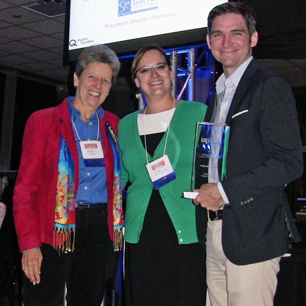 Former School Board member Anne Carroll and Facilities Director Tom Parent of Saint Paul Public Schools receive the award for Respect for Diversity, Inclusion and Culture from IAP2 USA President Leah Jaramillo